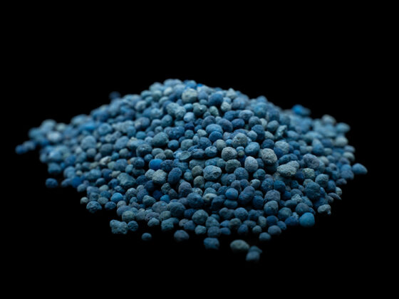 Blue NPK compound fertilizer granules in close-up